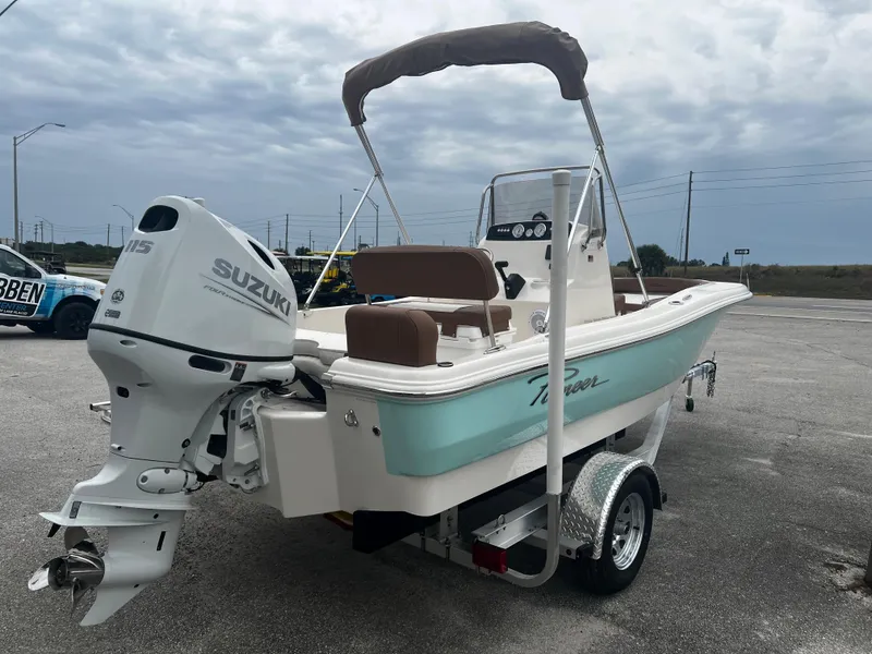 Slide: The Image of 2025 Pioneer 180 Islander boat with Suzuki outboard motor on a trailer. - 5