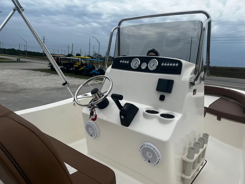 Slide: The Image of 2025 Pioneer 180 Islander boat console with steering wheel and gauges. - 9