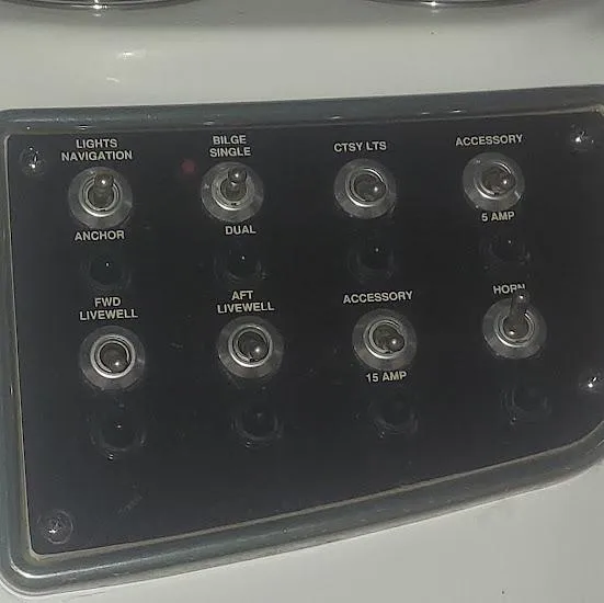 Slide: The Image of Control panel of a 2017 NauticStar 231 Coastal boat with various switches. - 16