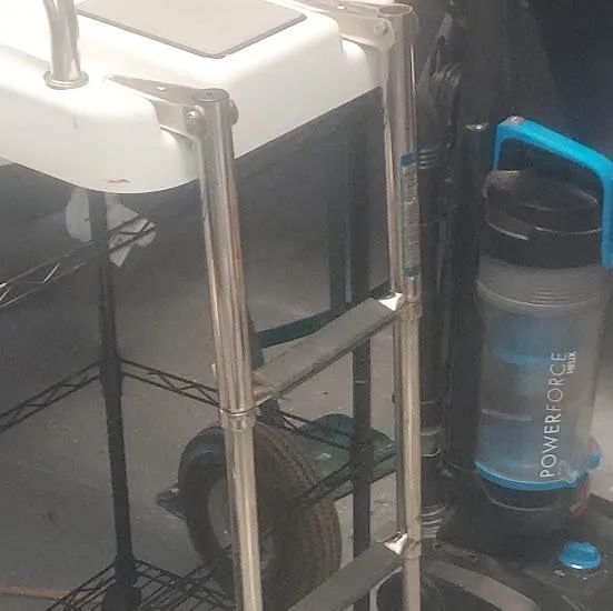 Slide: The Image of Close-up of a 2017 NauticStar 231 Coastal boat ladder and a PowerForce vacuum cleaner. - 17