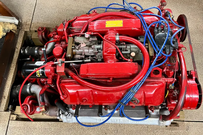 Slide: The Image of Red 1963 Lyman Sportsman engine with blue wires and visible components. - 14
