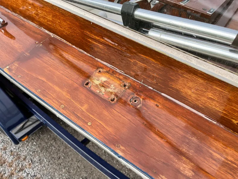 Slide: The Image of 1963 Lyman Sportsman boat with polished wooden surface and metal fittings. - 15