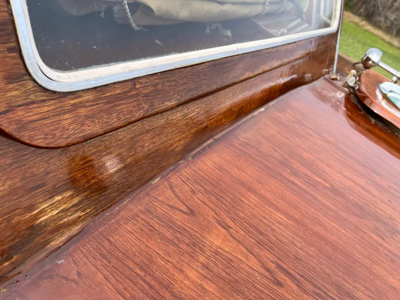 Slide: The Image of 1963 Lyman Sportsman boat with polished wooden deck and window detail. - 16