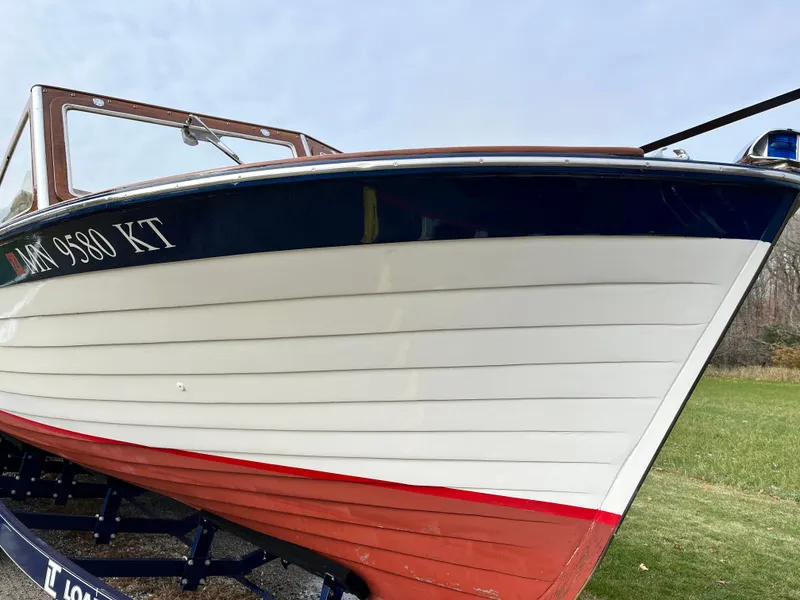 Slide: The Image of 1963 Lyman Sportsman boat with white and red hull on trailer. - 5