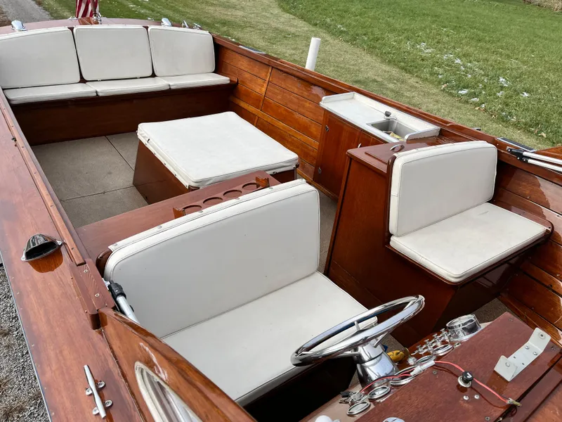 Slide: The Image of 1963 Lyman Sportsman boat interior with wooden finish and white seating. - 9