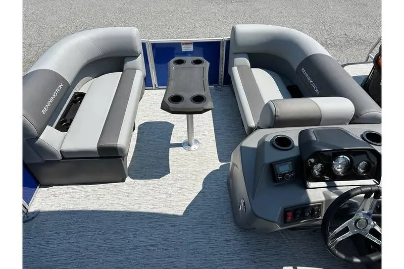 Slide: The Image of 2026 Bennington 20 SSB Swing Back pontoon boat interior with seating and control panel. - 11