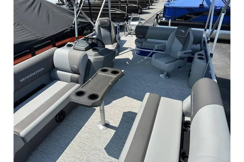 Slide: The Image of 2026 Bennington 20 SSB Swing Back pontoon boat interior with seating and table. - 18