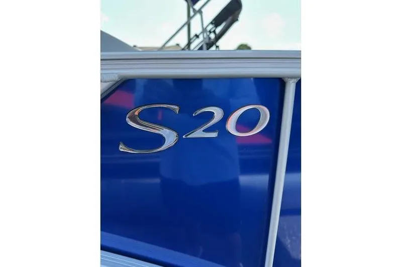 Slide: The Image of 2026 Bennington 20 SSB Swing Back boat with blue exterior and S20 emblem. - 20