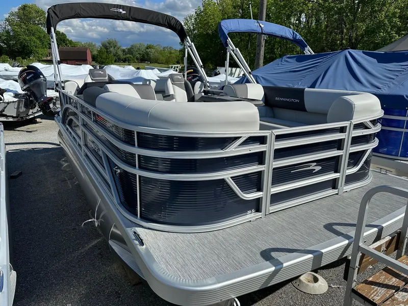 Slide: The Image of 2025 Bennington 20 SSR Quad Bench pontoon boat in stock, parked outdoors. - 1