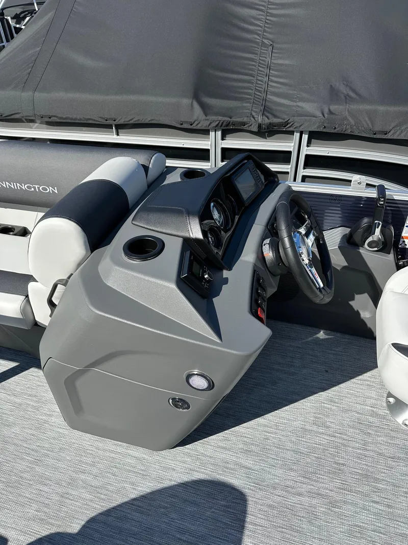 Slide: The Image of 2025 Bennington 20 SSR Quad Bench boat dashboard with steering wheel and controls. - 13