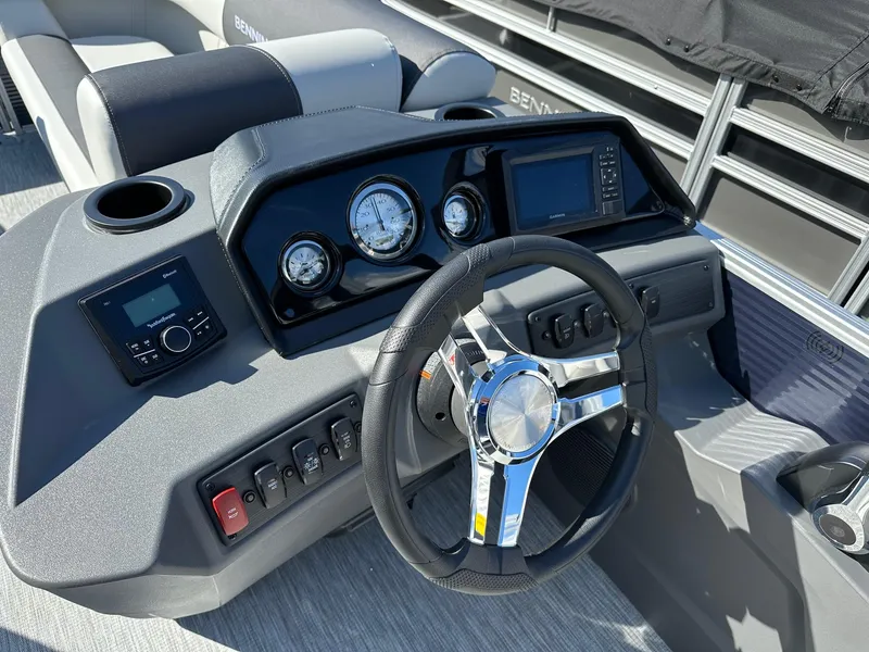 Slide: The Image of 2025 Bennington 20 SSR Quad Bench boat dashboard with steering wheel and controls. - 14