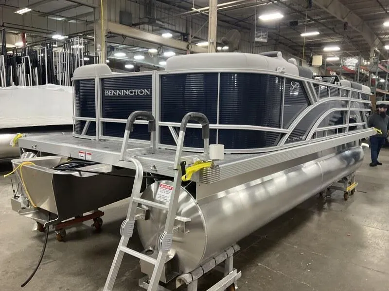 Slide: The Image of 2025 Bennington 20 SSR Quad Bench pontoon boat in stock at a showroom. - 2