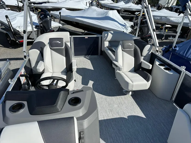 Slide: The Image of 2025 Bennington 20 SSR Quad Bench boat interior with modern seating and steering wheel. - 25