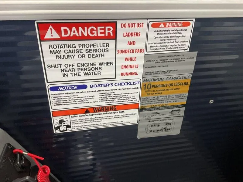 Slide: The Image of Warning labels on 2025 Bennington 20 SSR Quad Bench boat, highlighting safety precautions and capacity limits. - 6