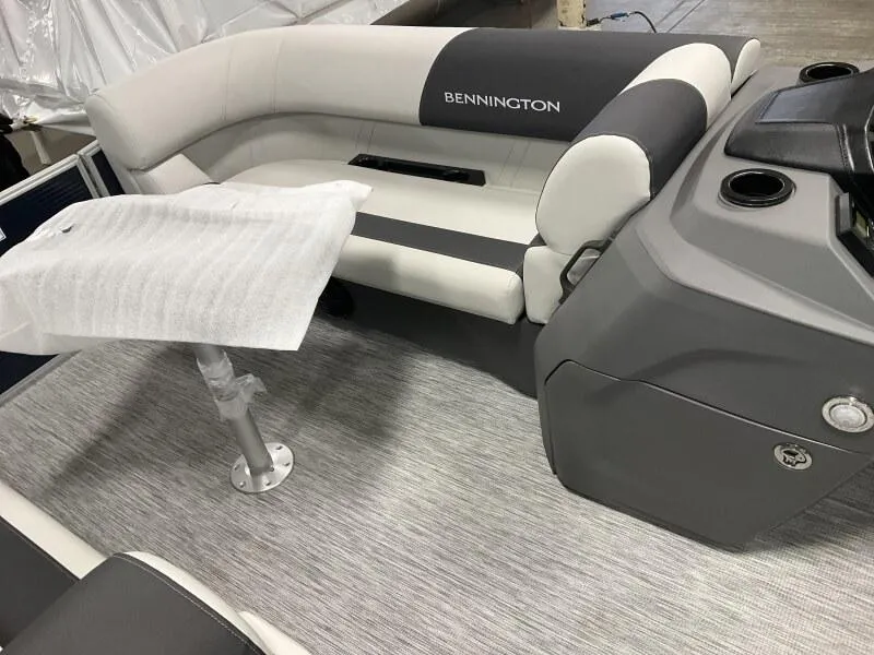 Slide: The Image of 2025 Bennington 20 SSR Quad Bench interior with gray seating and table. - 7