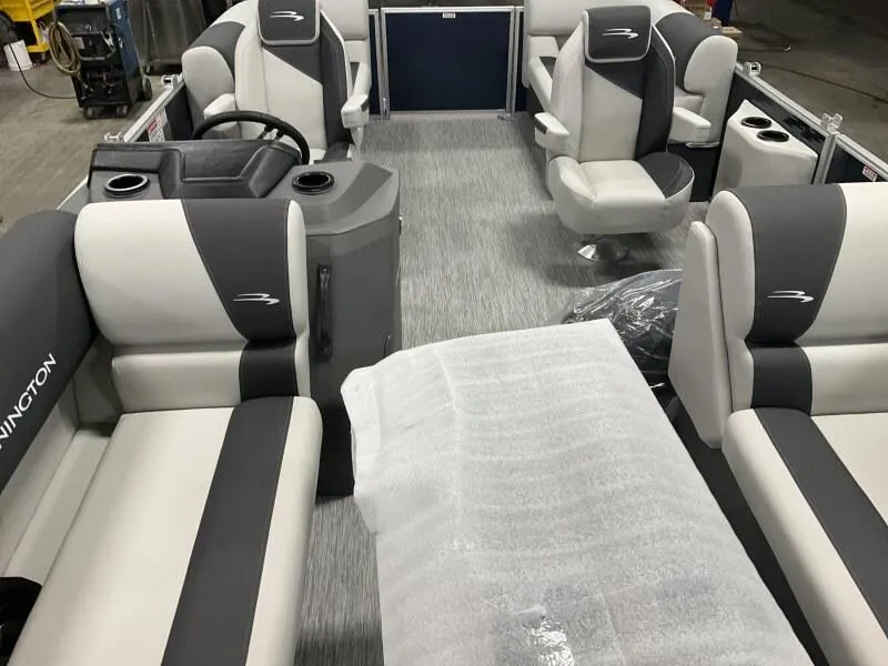 Slide: The Image of 2025 Bennington 20 SSR Quad Bench interior with gray and white seating. - 8