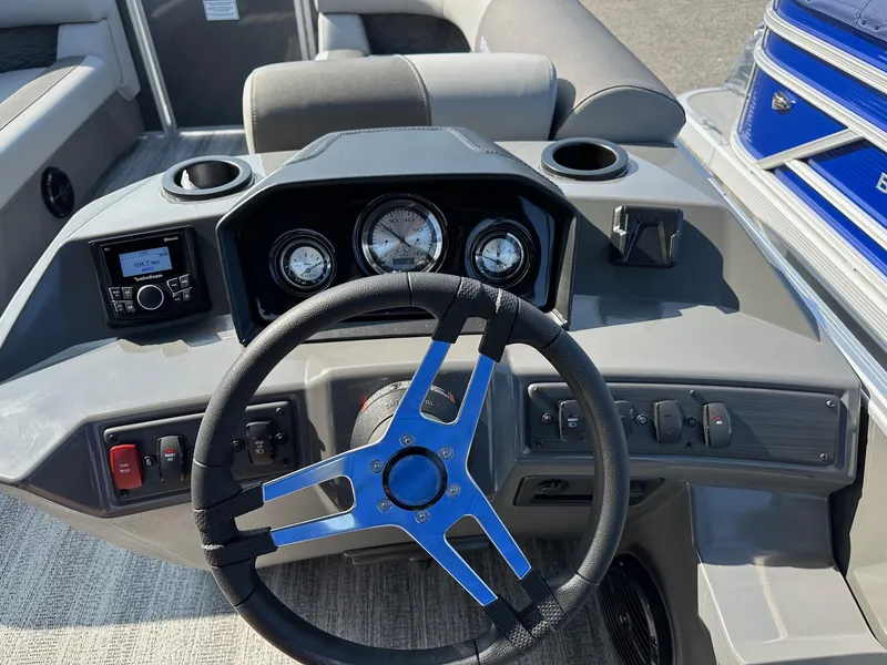 Slide: The Image of 2025 Bennington 188 SL Family boat dashboard with steering wheel and gauges. - 10