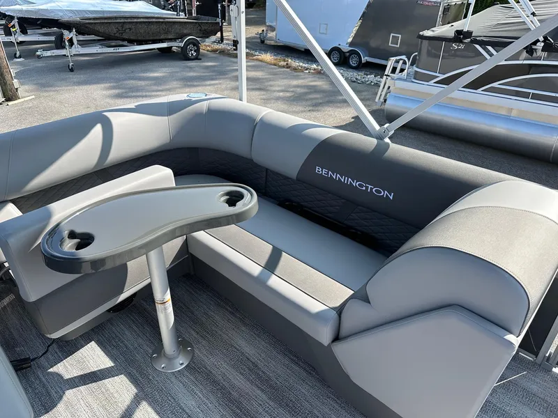 Slide: The Image of 2025 Bennington 188 SL Family boat interior with gray seating and table. - 22