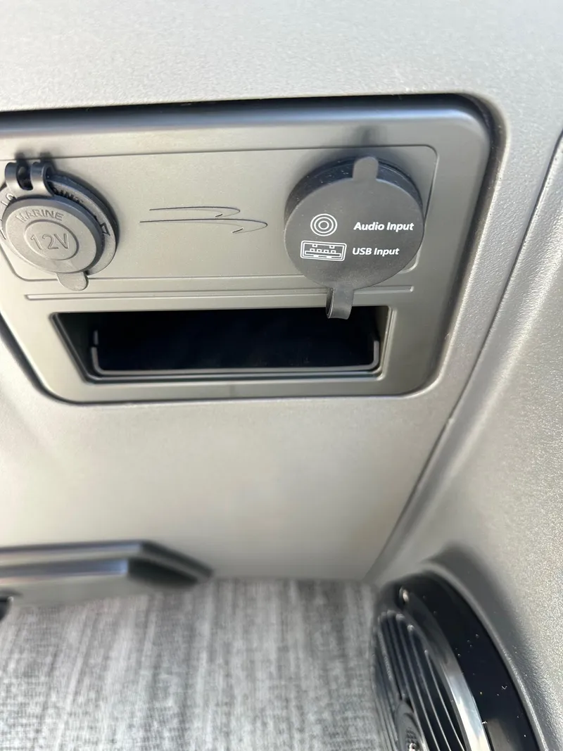Slide: The Image of 2025 Bennington 188 SL Family audio and USB input panel with 12V outlet. - 23