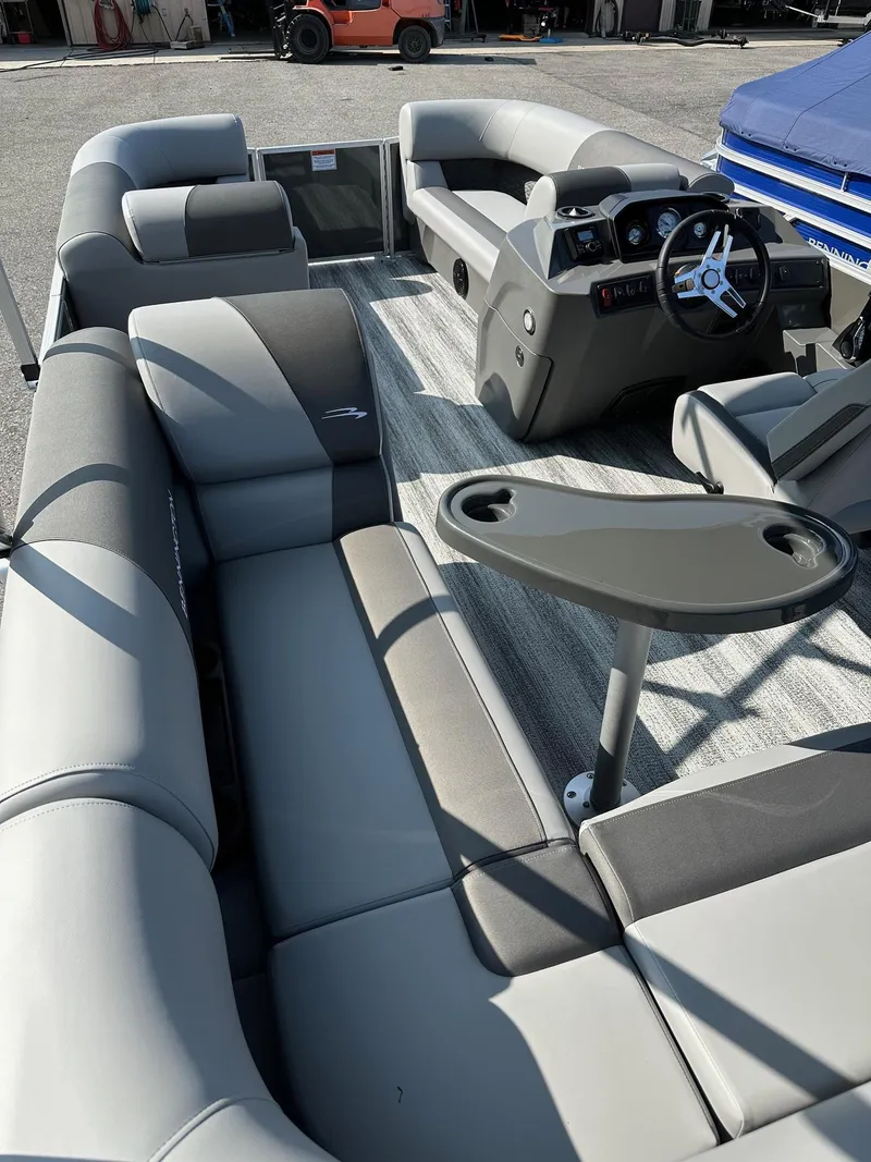 Slide: The Image of 2025 Bennington 188 SL Family pontoon boat interior with gray seating and steering console. - 24