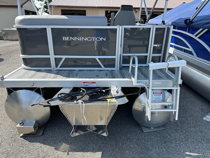 Slide: The Image of 2025 Bennington 188 SL Family pontoon boat, rear view with ladder and pontoons. - 25