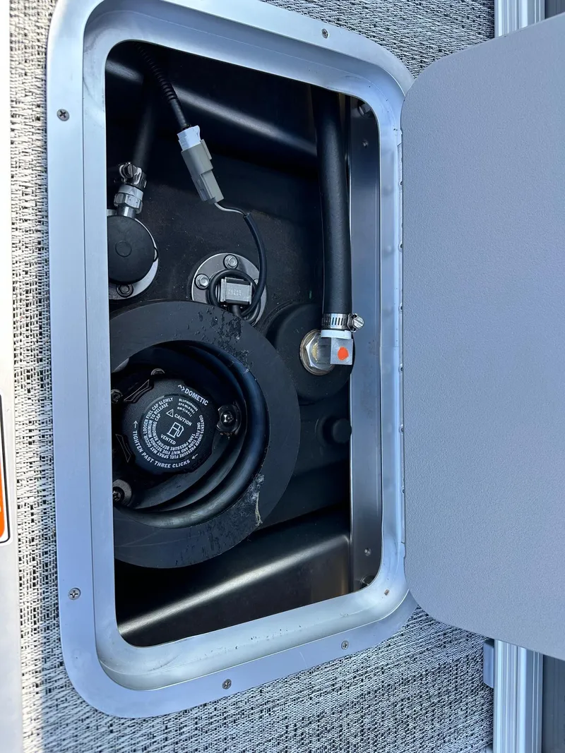 Slide: The Image of Fuel compartment of 2025 Bennington 188 SL Family boat, showing hoses and connections. - 26