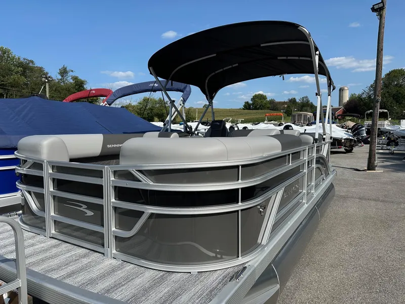 Slide: The Image of 2025 Bennington 188 SL Family pontoon boat with canopy, parked outdoors. - 5