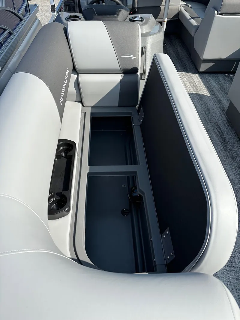 Slide: The Image of 2025 Bennington 188 SL Family boat interior with open storage compartment and cup holders. - 7