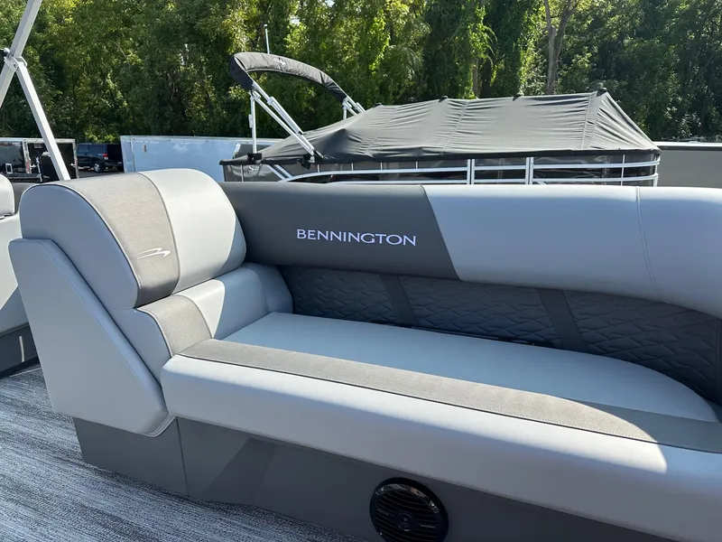 Slide: The Image of 2025 Bennington 188 SL Family boat interior with gray seating and logo. - 8