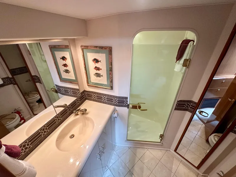 Slide: The Image of Luxurious bathroom in 2000 Viking 65 Sport Fisher yacht with elegant fixtures and decor. - 12