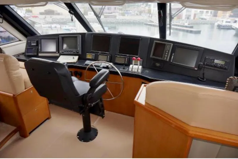 Slide: The Image of Cockpit of 2000 Viking 65 Sport Fisher with navigation equipment and steering wheel. - 16
