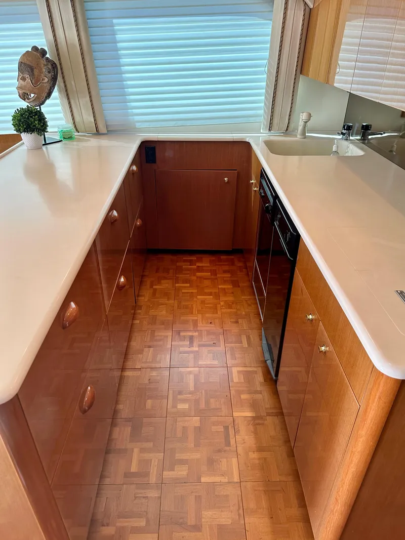 Slide: The Image of Interior of 2000 Viking 65 Sport Fisher yacht kitchen with wood cabinetry and parquet flooring. - 4