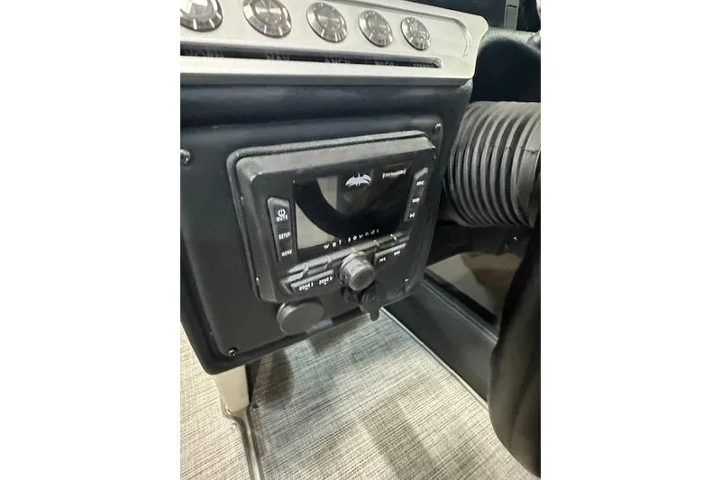 Slide: The Image of 2024 Crownline 240 SS dashboard with control panel and gauges. - 13