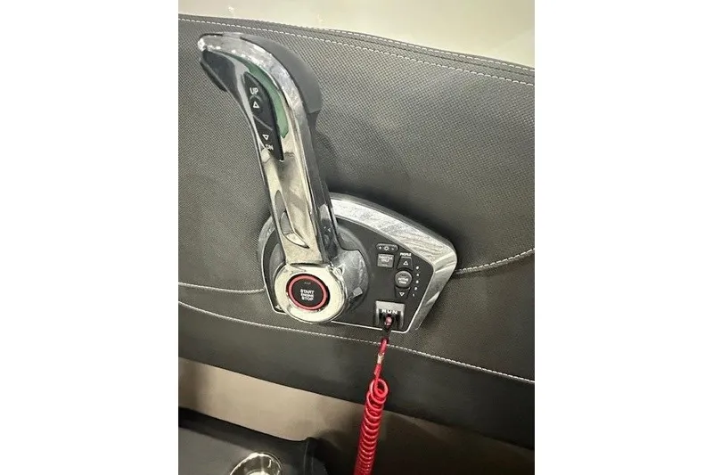 Slide: The Image of 2024 Crownline 240 SS boat throttle control with start/stop button and red safety cord. - 14