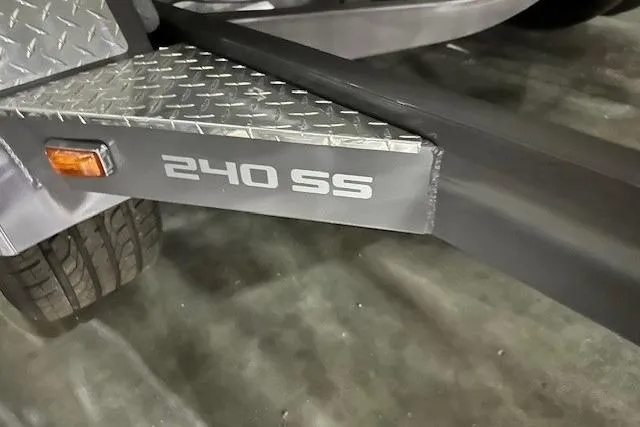 Slide: The Image of 2024 Crownline 240 SS trailer detail with diamond plate and model branding. - 16
