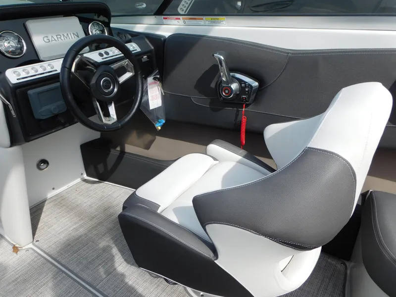 Slide: The Image of 2024 Crownline 240 SS boat interior with modern seating and sleek design in showroom. - 5