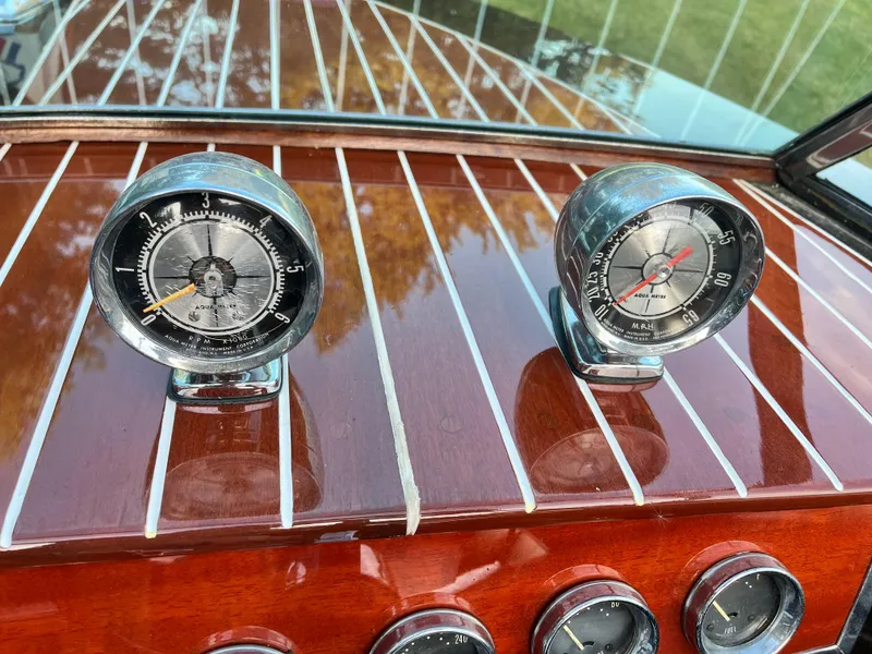 Slide: The Image of Vintage 1966 Century Arabian boat dashboard with classic gauges and wood paneling. - 14