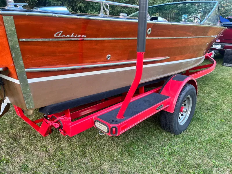 Slide: The Image of 1966 Century Arabian boat on red trailer, showcasing classic wooden design. - 3