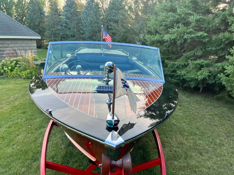 Slide: The Image of 1966 Century Arabian boat with American flag, displayed on grass with trees in background. - 6