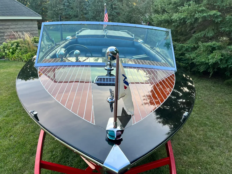 Slide: The Image of 1966 Century Arabian boat with polished wood finish and chrome details, displayed on grass. - 7