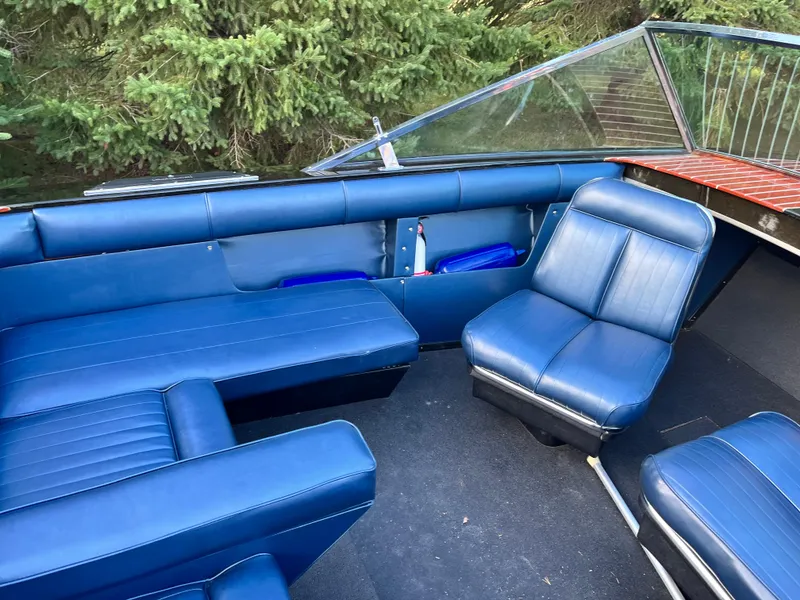 Slide: The Image of 1966 Century Arabian boat interior with blue leather seats and windshield, surrounded by trees. - 9