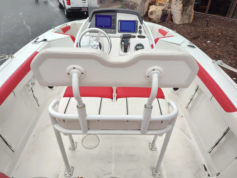 Slide: The Image of 2022 Tahoe 2150cc boat interior with red and white seating, dual screens, and steering wheel. - 2