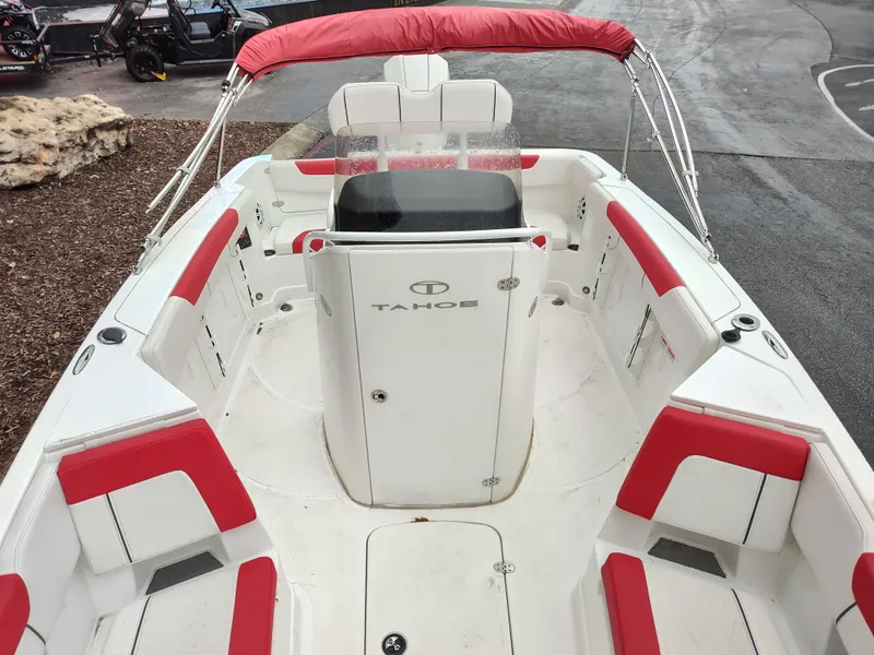 Slide: The Image of 2022 Tahoe 2150cc boat with red and white seating, docked outdoors. - 3