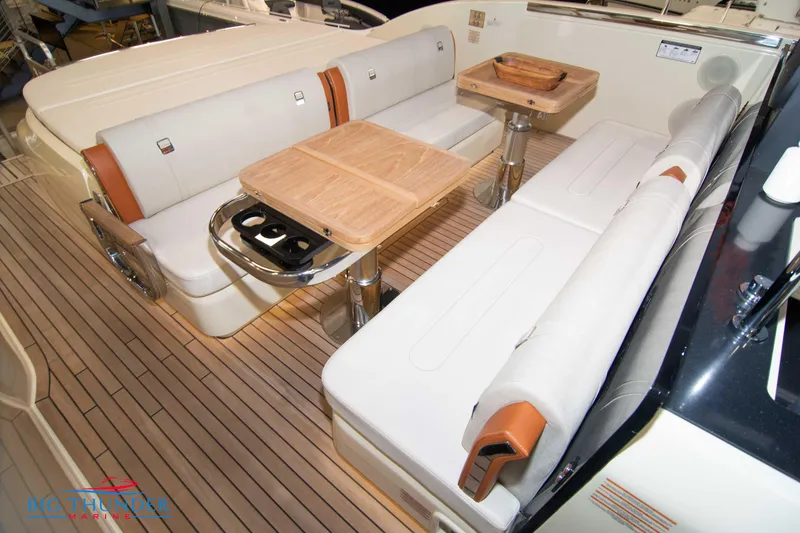 Slide: The Image of Luxurious seating area on 2024 Invictus TT420 yacht with wooden tables and white cushions. - 19