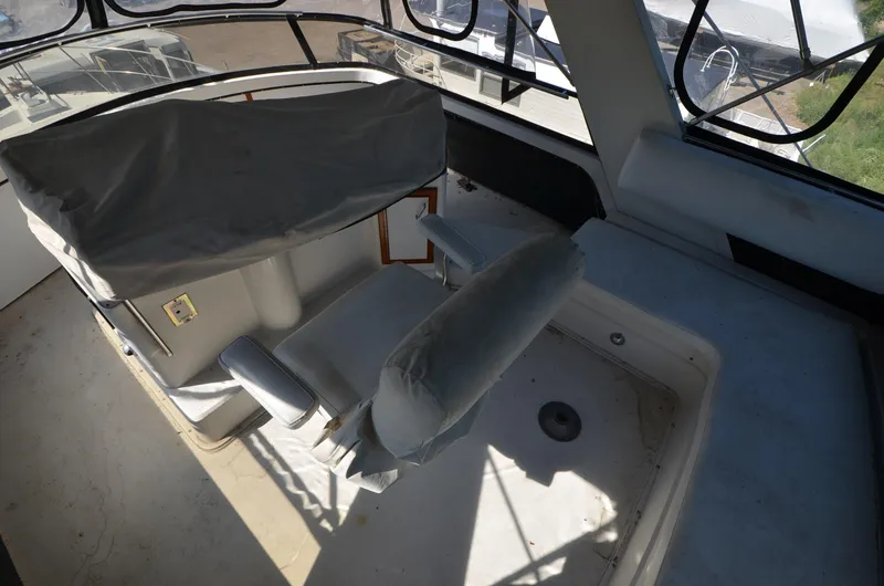 Slide: The Image of 1986 Carver Cockpit 4227 MY interior with covered seating and helm. - 10