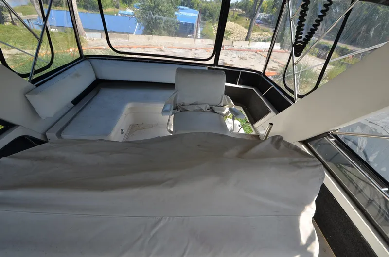 Slide: The Image of 1986 Carver Cockpit 4227 MY interior with helm chair and panoramic windows. - 11