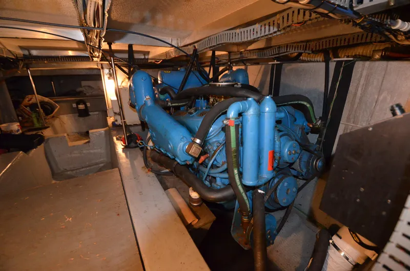 Slide: The Image of 1986 Carver Cockpit 4227 MY engine room with blue engine components. - 16