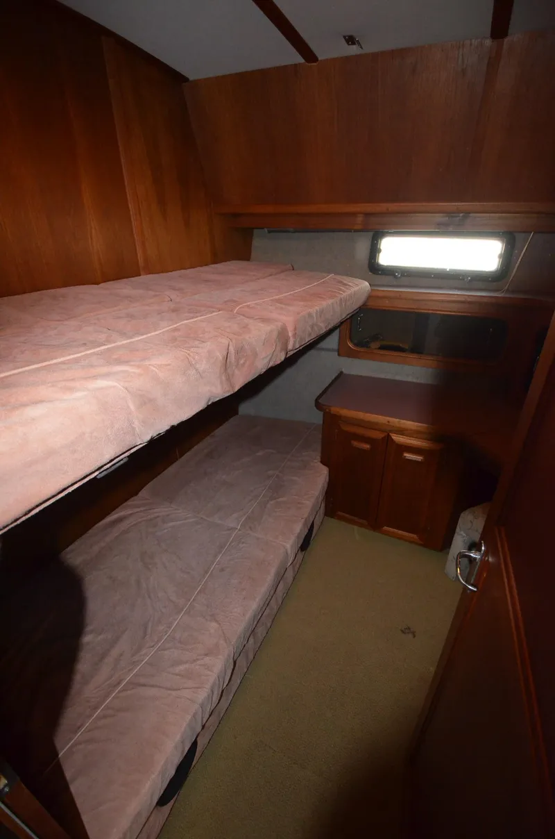 Slide: The Image of 1986 Carver Cockpit 4227 MY cabin with bunk beds and wooden interior. - 17