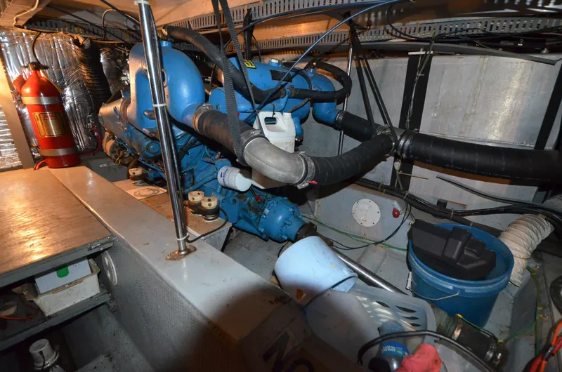 Slide: The Image of Engine room of 1986 Carver Cockpit 4227 MY with blue machinery and equipment. - 18