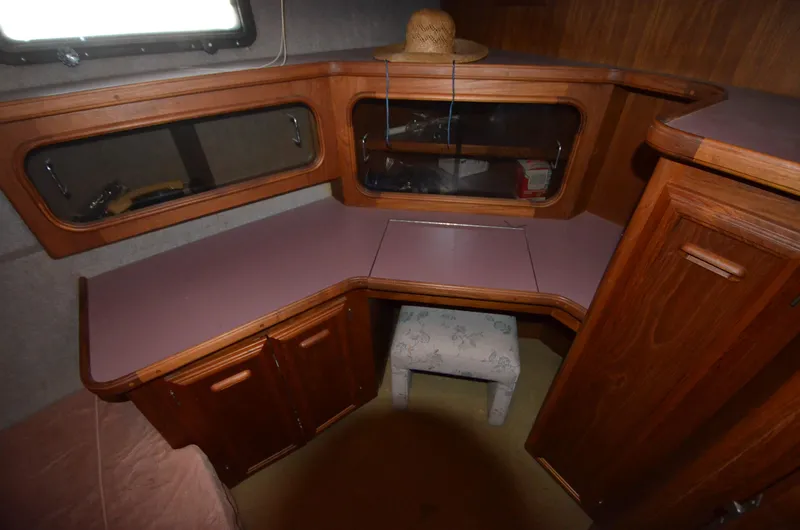 Slide: The Image of 1986 Carver Cockpit 4227 MY interior with wooden cabinetry and seating area. - 19
